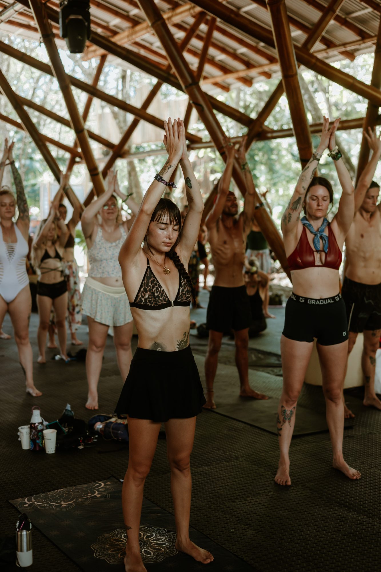 A room, arms raised, breathing together